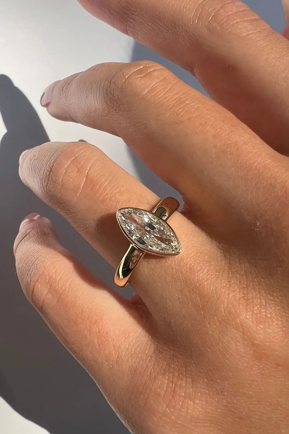 A marquise, set flush into gold